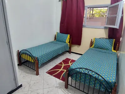 a room with two beds and a window at Apartment Hamria Meknes BT in Meknès