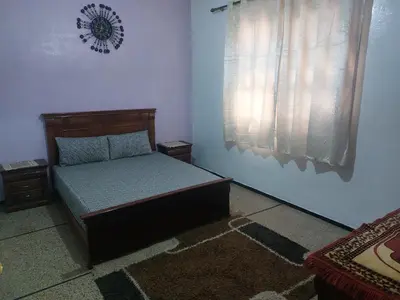 a small bedroom with a bed and a window at Apartment Hamria Meknes BT in Meknès