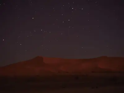 a starry night in the desert with sand dunes at Tuareg Luxury Camp in Merzouga