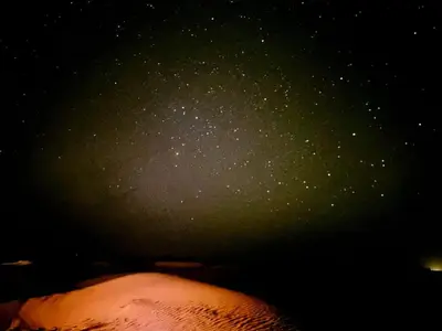a starry night sky with a persons head at Tuareg Luxury Camp in Merzouga