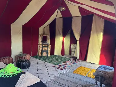 a room with a tent with a bed in it at Tuareg Luxury Camp in Merzouga