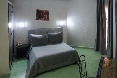 a bedroom with a bed in a room at Hotel Nouzha in Fès