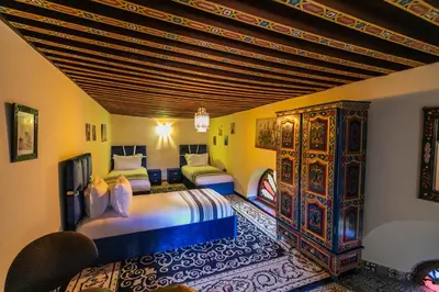 a bedroom with two beds and a wooden ceiling at Riad Hadia Fes - Prestige Stay in Fès