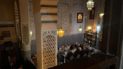 a group of people sitting at a table in a room at Riad Hadia Fes - Prestige Stay in Fès