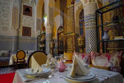 a dining room with a table with plates on it at Riad Hadia Fes - Prestige Stay in Fès