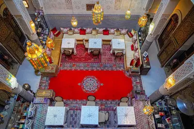 an overhead view of a dining room with a red carpet at Riad Hadia Fes - Prestige Stay in Fès
