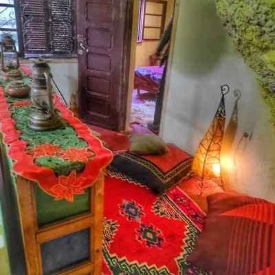 a room with two beds and a table with a bed sidx sidx sidx at Grotte Thami in Bhalil
