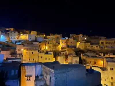 a view of a city at night at Grotte Thami in Bhalil