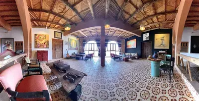 a large room with couches and chairs in a building at taman'art space in Aït Ben Haddou