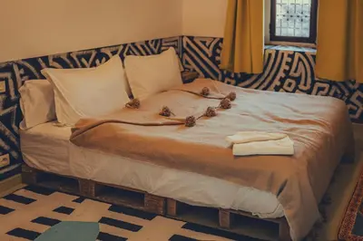 a bed with three birds sitting on top of it at taman'art space in Aït Ben Haddou