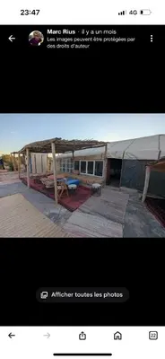a picture of a picture of a building with a picnic table at Kasbah Azalay Merzouga takojt in Merzouga