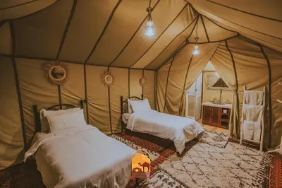 a bedroom with two beds in a tent at Trek desert Morocco Sarl in Taouz
