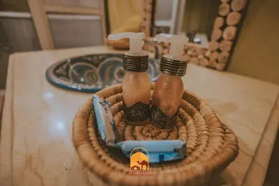 two bottles in a wicker basket on a table at Trek desert Morocco Sarl in Taouz