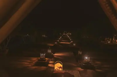 a view of a garden at night with lights at Trek desert Morocco Sarl in Taouz