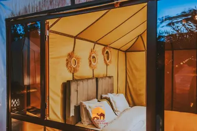 a room with a bed inside of a tent at Trek desert Morocco Sarl in Taouz
