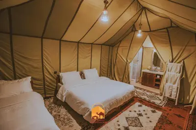 a bedroom with a bed in a tent at Trek desert Morocco Sarl in Taouz