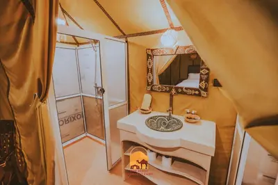 a bathroom with a sink and a mirror at Trek desert Morocco Sarl in Taouz
