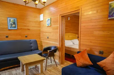 a room with a couch and a bed and a table at Hôtel les truites in Imouzzer Kandar