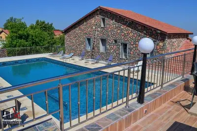 a swimming pool on a balcony with a fence at Hôtel les truites in Imouzzer Kandar