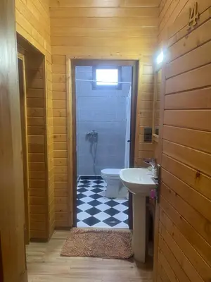 a bathroom with a white toilet and a sink at Hôtel les truites in Imouzzer Kandar