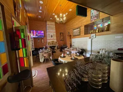 a restaurant with a dining room with tables and chairs at Hôtel les truites in Imouzzer Kandar