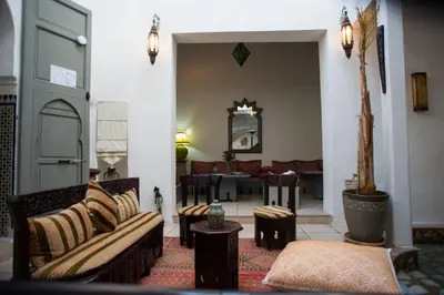 a living room with couches and a table at Riad Safir in Meknès