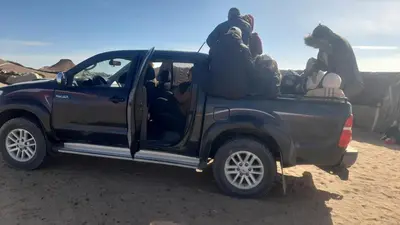 a group of people sitting in the back of a truck at Luxury trek desert camp in Merzouga