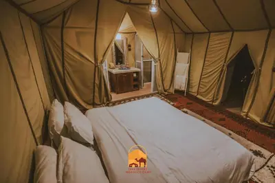 a bedroom with a bed in a tent at Luxury trek desert camp in Merzouga