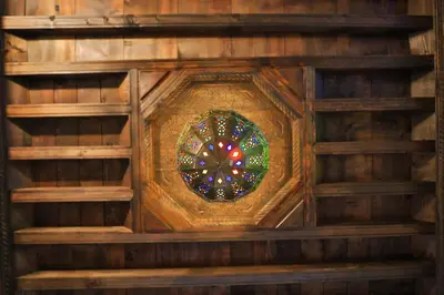 a stained glass window in a wooden building at Dar Chez Khadija in Fès