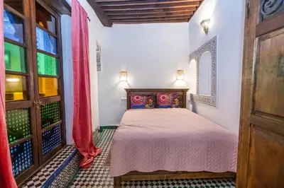 a bedroom with a bed and a window at Dar Chez Khadija in Fès
