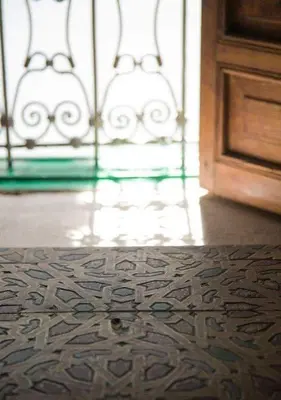 a room with a wooden floor and a door at dar lmallouki in Fès