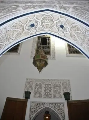 an archway in a building with a ceiling and a window at dar lmallouki in Fès