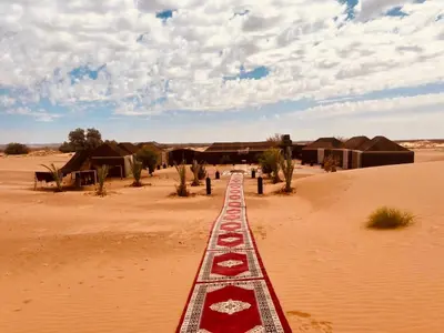a track in the middle of the desert at Merzouga Glamping Camp in Merzouga