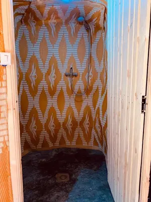 a hallway with a patterned wall in a room at Merzouga Glamping Camp in Merzouga