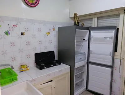 a kitchen with an open refrigerator and a sink at Appartement Hamria RiF in Meknès