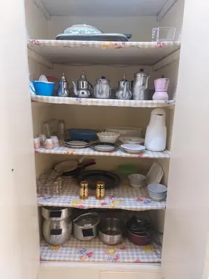 a pantry filled with dishes and pots and pans at Appartement Hamria RiF in Meknès