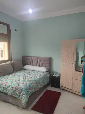 a bedroom with a bed and a dresser and a mirror at The good stay 1midelt in Midelt
