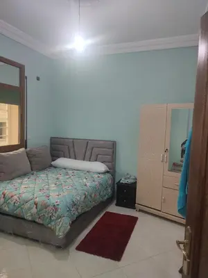a bedroom with a bed and a dresser with a mirror at The good stay 1midelt in Midelt