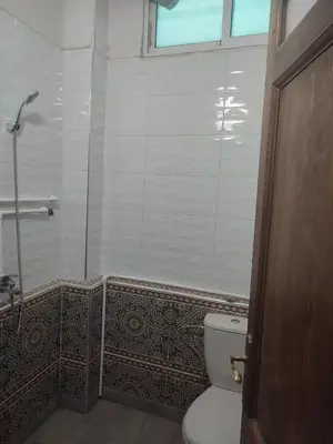 a bathroom with a toilet and a glass shower at The good stay 1midelt in Midelt