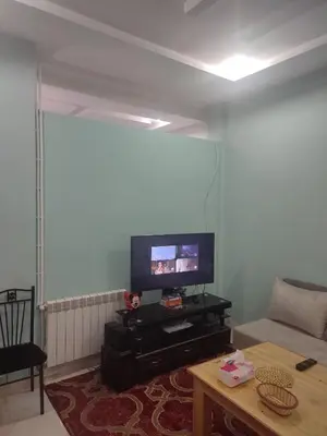 a living room with a couch and a tv at The good stay 1midelt in Midelt