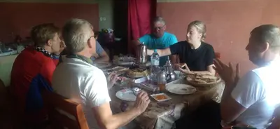 a group of people sitting around a table eating food at KASBAH Atlas-Aberdouz in Aït Hattab