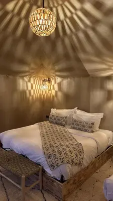 a bedroom with a bed in a tent at Starlit Luxury Camp in Merzouga