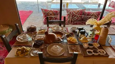a table with food on it with a table at Starlit Luxury Camp in Merzouga