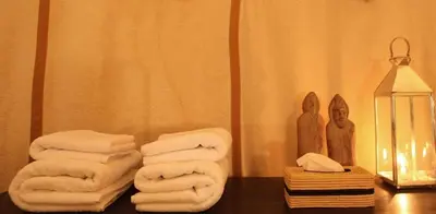 a pile of towels on a table in a bathroom at Merzouga Camel's & Camp in Merzouga