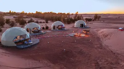 an aerial view of four domes in the desert at Merzouga Camel's & Camp in Merzouga
