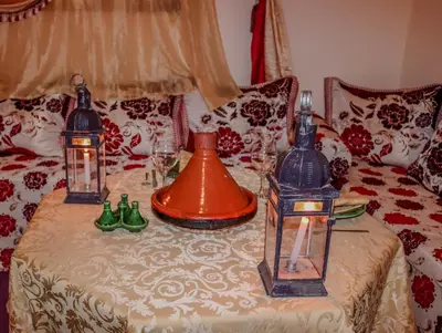 a table with three lanterns on top of a couch at Gîte Ait lmaalam chez Ahmed in Skoura