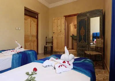 a bedroom with two beds with towels on them at villa saada in Marrakech