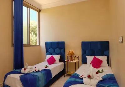 a bedroom with two beds with stuffed animals on them at villa saada in Marrakech