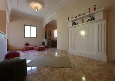 a large living room with a large stone fireplace at villa saada in Marrakech
