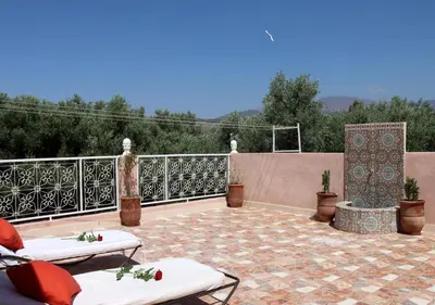 a patio with two lounge chairs on a patio at villa saada in Marrakech